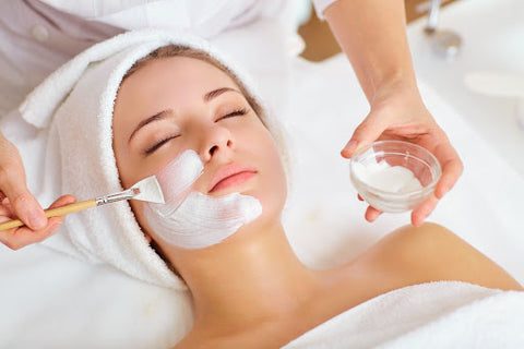 Facial specialist giving a woman a facial service