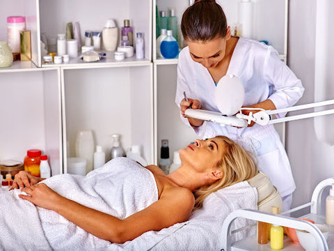 Skincare specialist servicing a woman