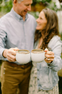 Eric and Carol B. each holding a cup of coffee