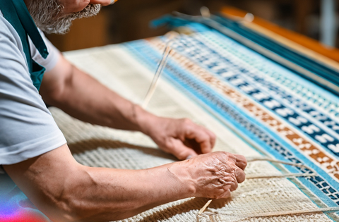 Artisan weaving handmade carpet