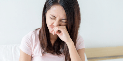 Woman sneezing