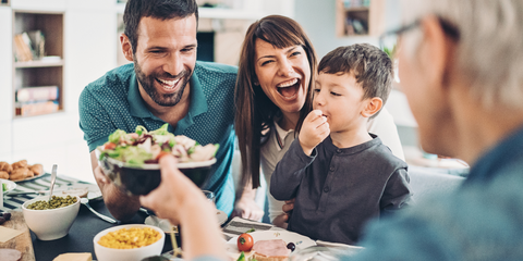 Family laughing around a table