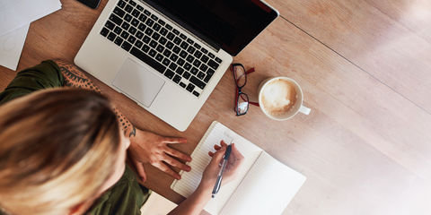 Woman at computer making a list