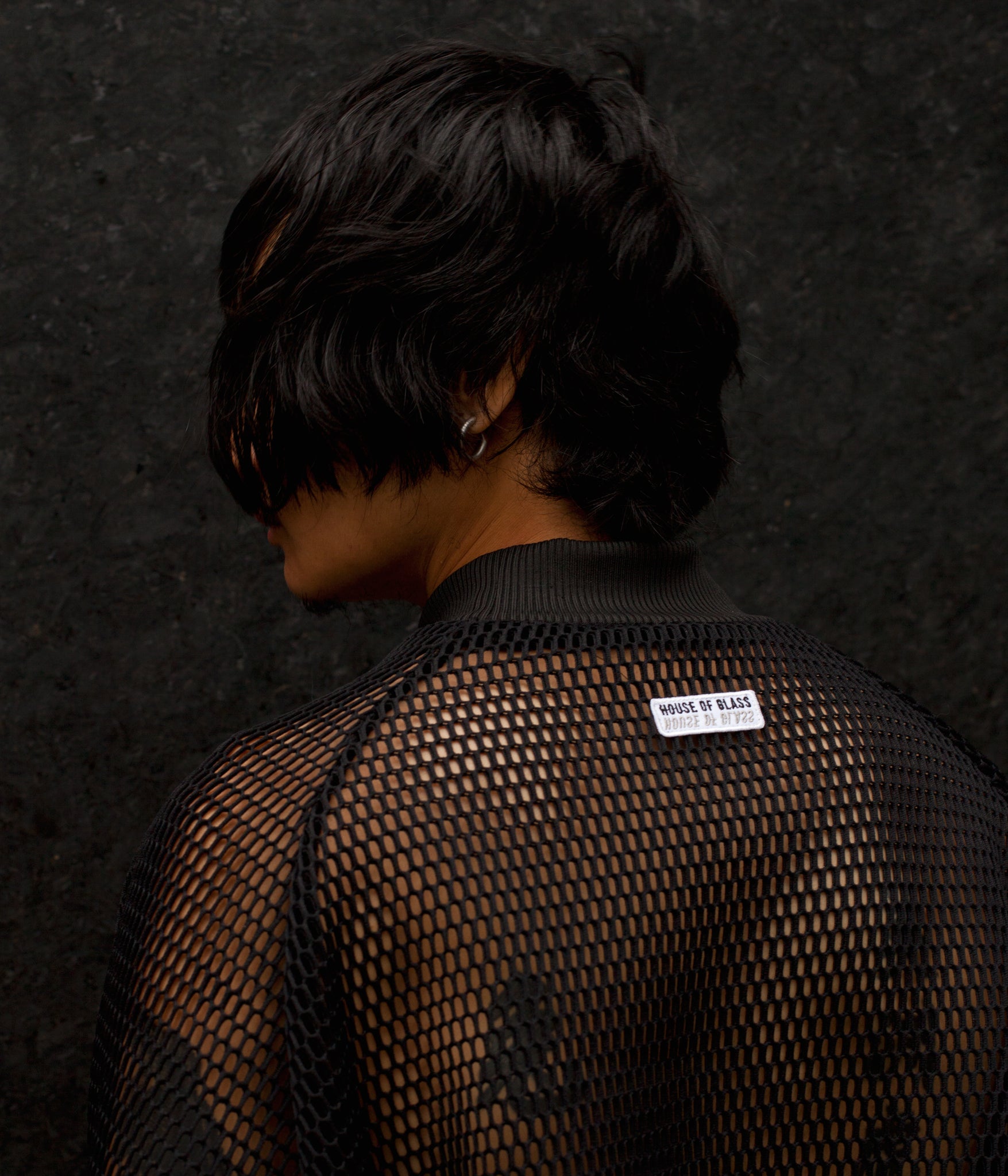 picture showing model from behind wearing the House of Glass Hot Mesh Tracksuit and showing the House of Glass logo patch