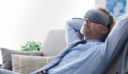man_at_work_relaxing_with_a_sleep_mask