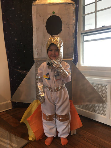 Little boy in space astronaut costume for rocket birthday party