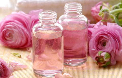 Rose flowers and bottles of rose water