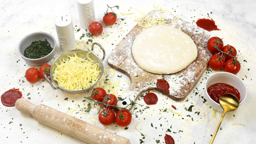 Messy pizza ingredients on table