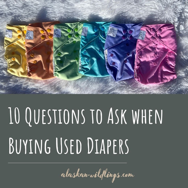 "10 Questions to Ask When Buying Used Diapers" with a rainbow of Alaskan Wildlings pocket diapers. 
