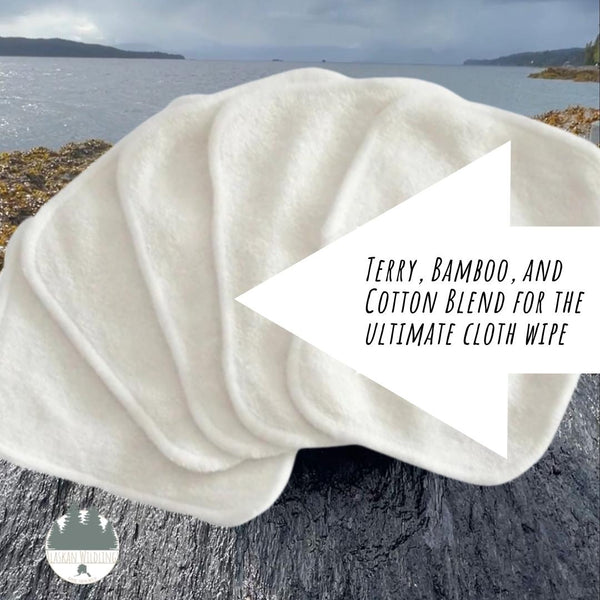 Cloth wipes splayed out in the foreground, Alaskan ocean in the background.