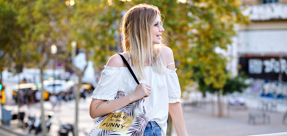 Woman wearing white shoulder back leaning on railing | Pakapalooza