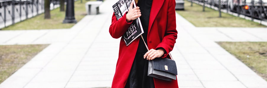 Women in red coat walking with a crossbody bag | Pakapalooza