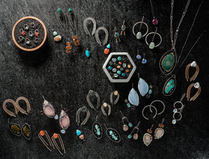 Hand crafted sterling silver jewelry featuring a variety of gemstones. Pictured are earring and necklace designs inspired by mythological women.  Stone types include turquoise, prehnite, carnelian, moonstone, agate, ocean jasper, labradorite, and quartz. 