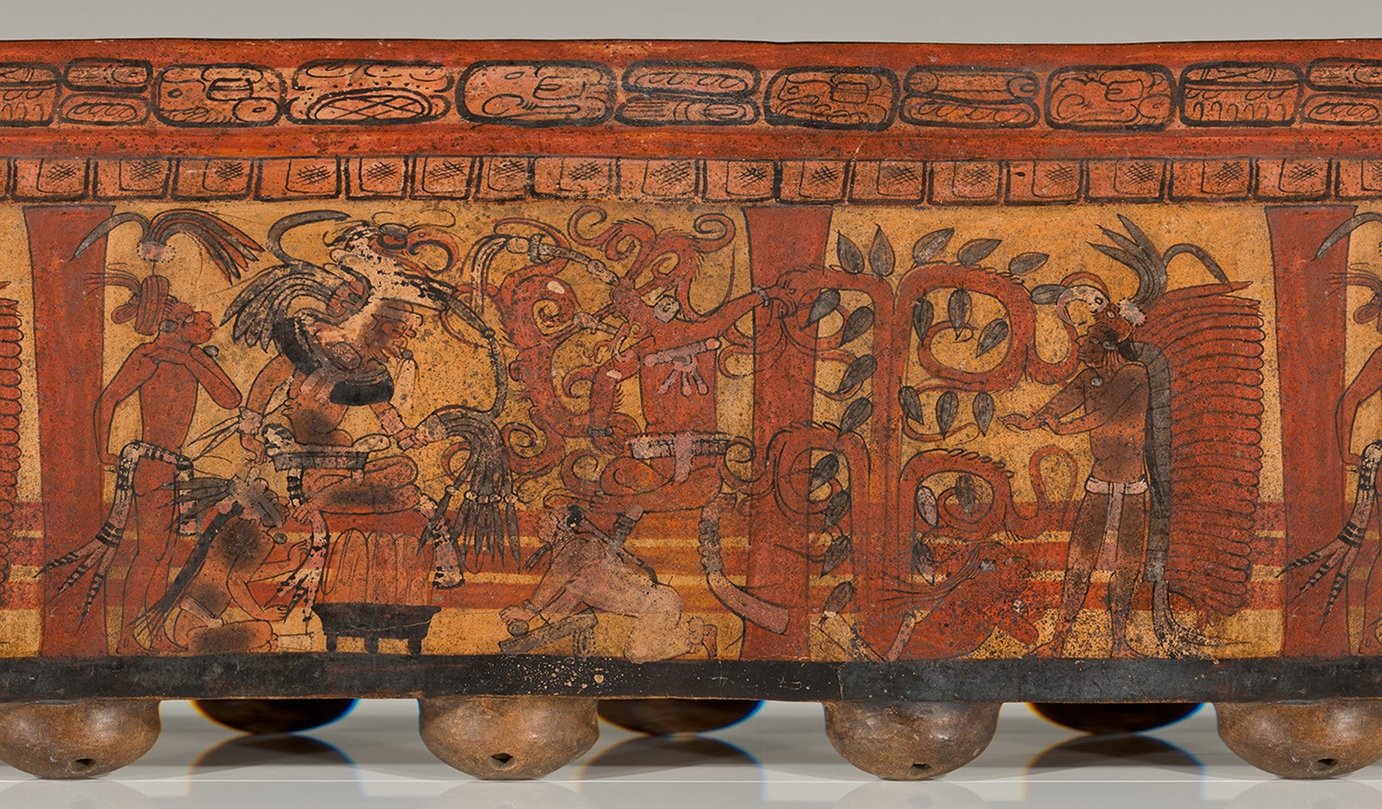 Panoramic take on the cylinder vessel depicting the creation of cacao by Mayan god.