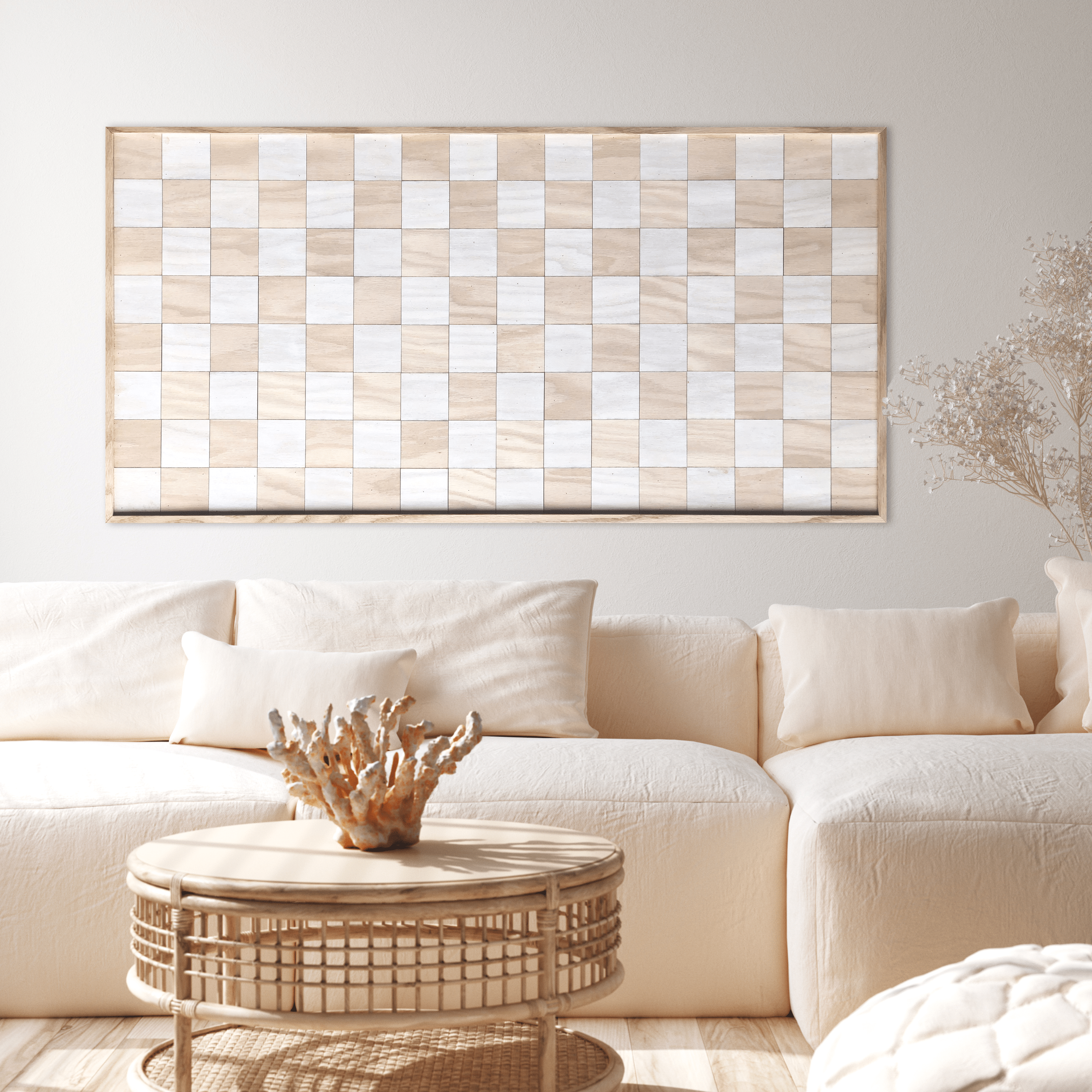 A cozy living room with a white couch and a checkered wall art piece.