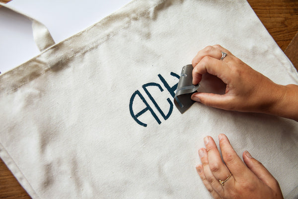 Want to craft your own DIY monogrammed tote bag? Follow these simple steps for using A Makers’ Studio easy monogram stencils to create a DIY tote that is custom to you.