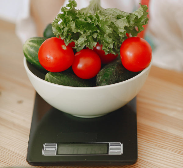 Chef using compact scale in professional kitchen