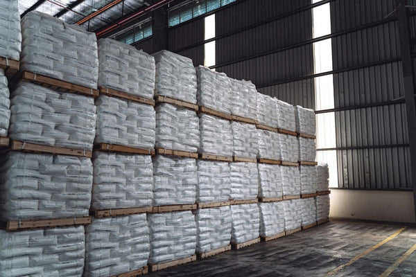 Warehouse workers assembling stackable pipe racks