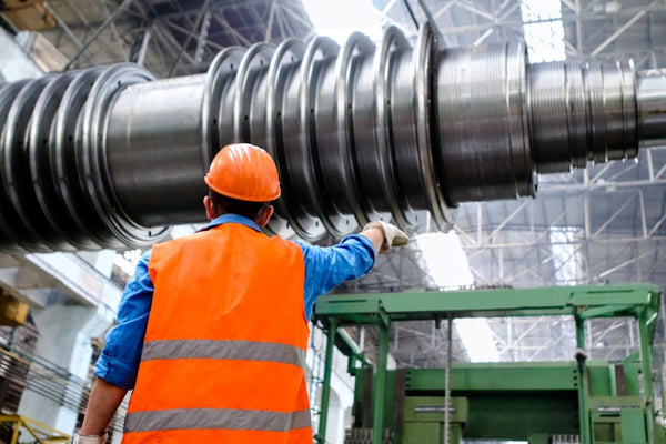 Worker safely organizing pipes in stacking frame system