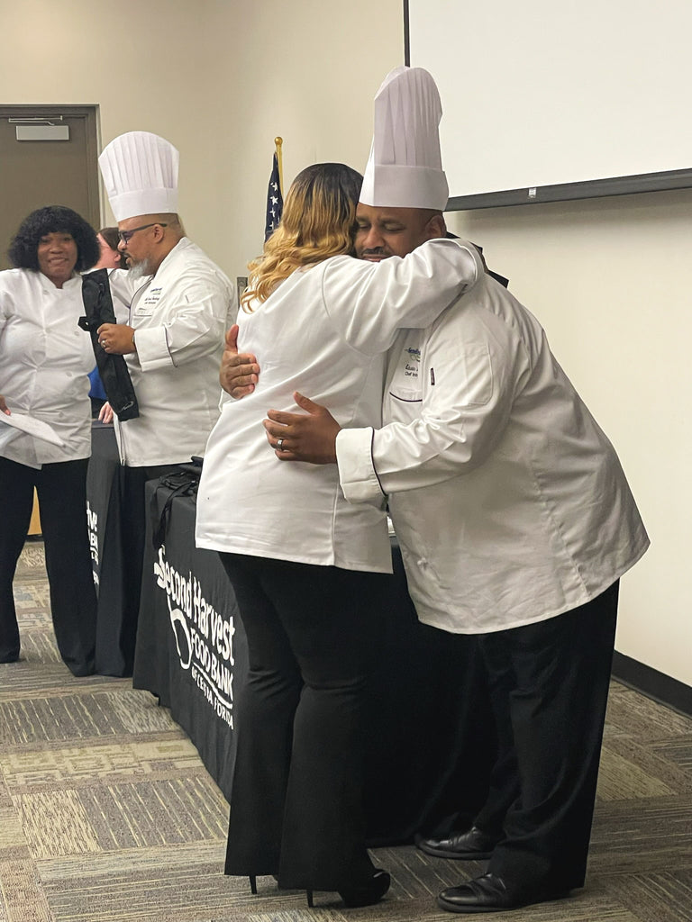 Instructors celebrating with graduates at Culinary Training Program graduation