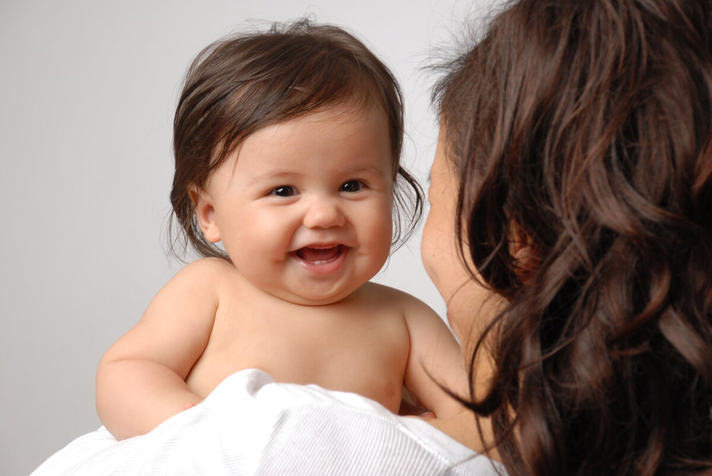 mother burping baby to help with reflux