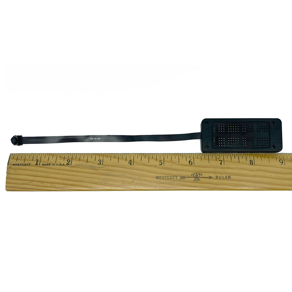 measurment of small spy camera next to ruler