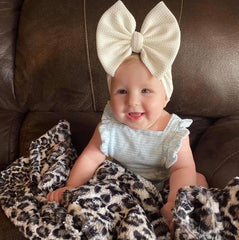 Baby sitting with minky blanket in leopard print