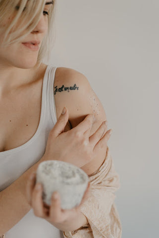 Person rubbing exfoliating scrub on arm, for Ivy Leaf Skincare blog 