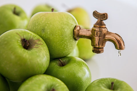 Faucet attached to green apple, for Ivy Leaf Skincare blog