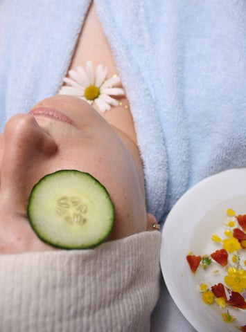 Person with cucumber slice on eye, for Ivy Leaf Skincare blog