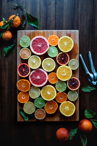 Tray of grapefruit, lemon, limes and other citrus fruits to represent vitamin C, for Ivy Leaf Skincare blog