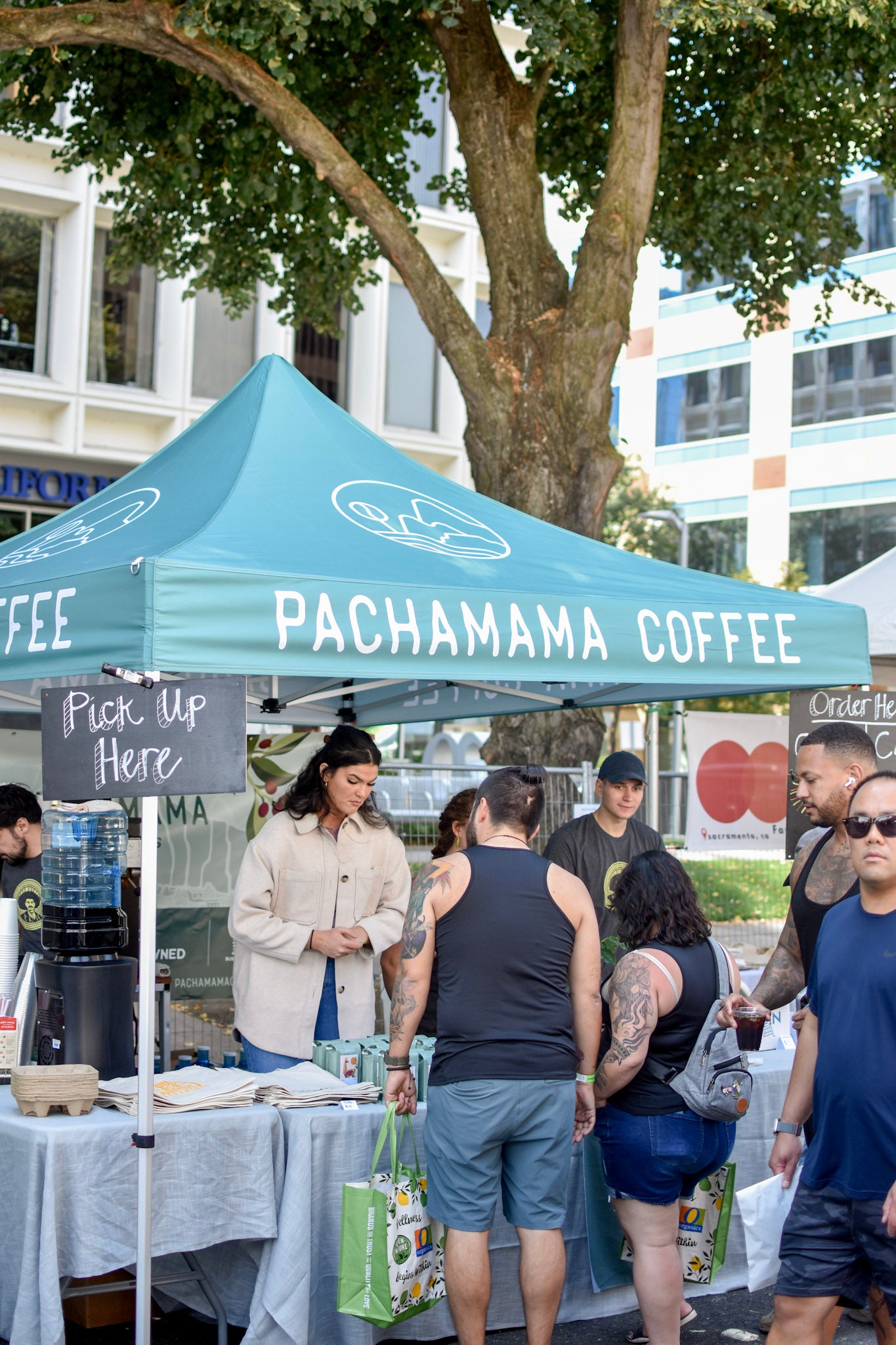 people standing in front of Pachamama booth to buy coffee