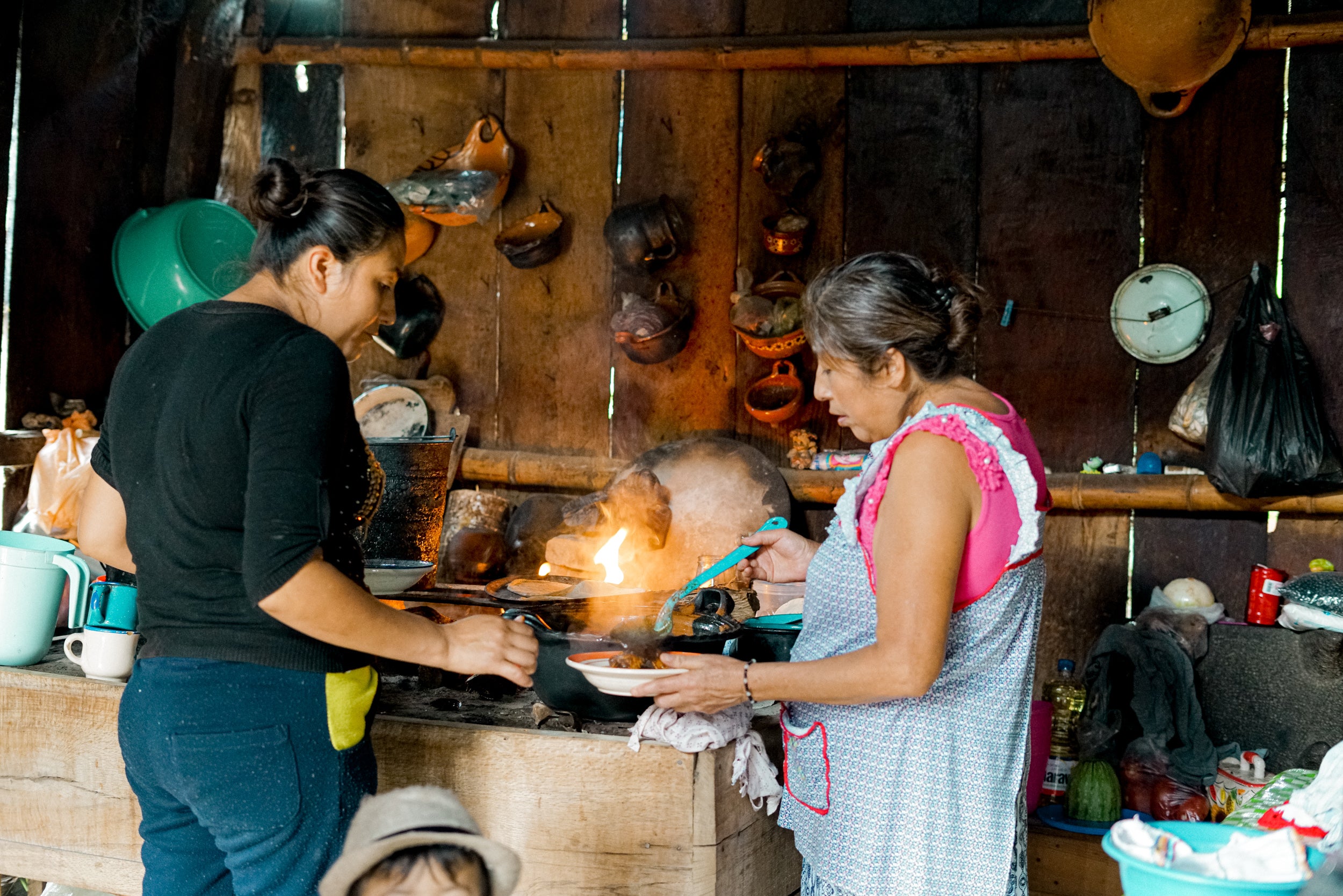 woman and daughter in kitchen, farming community Mexico