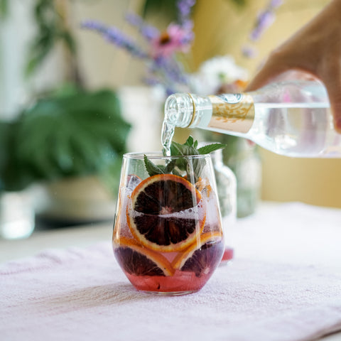 pouring tonic water over ice