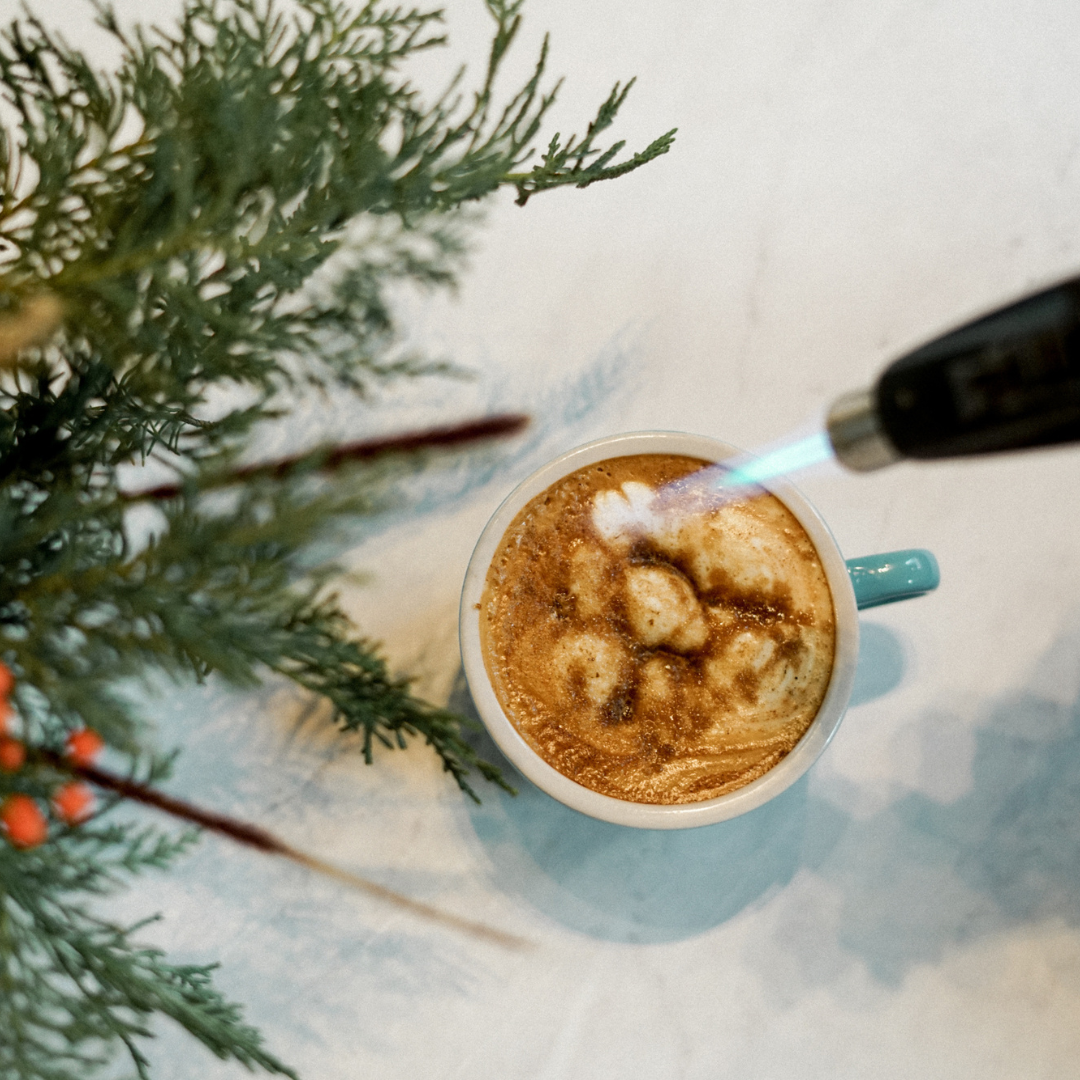 Maple Brulee Latte. Barista tourching top of latte