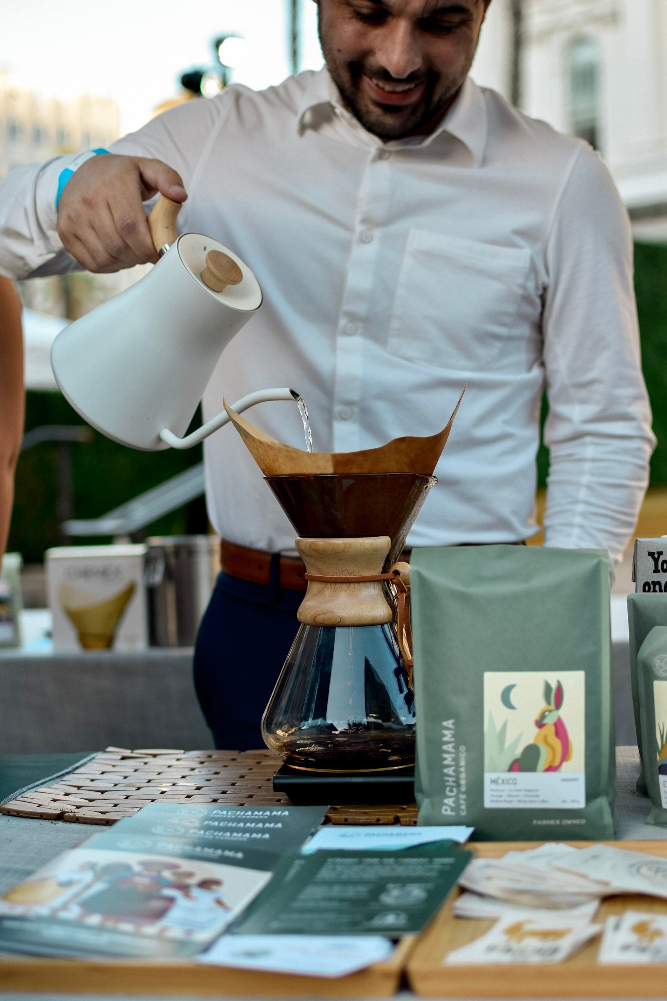 man pouring water into chemex brewer