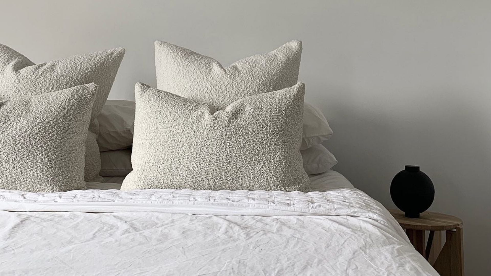 White Hommey cushions on a bed