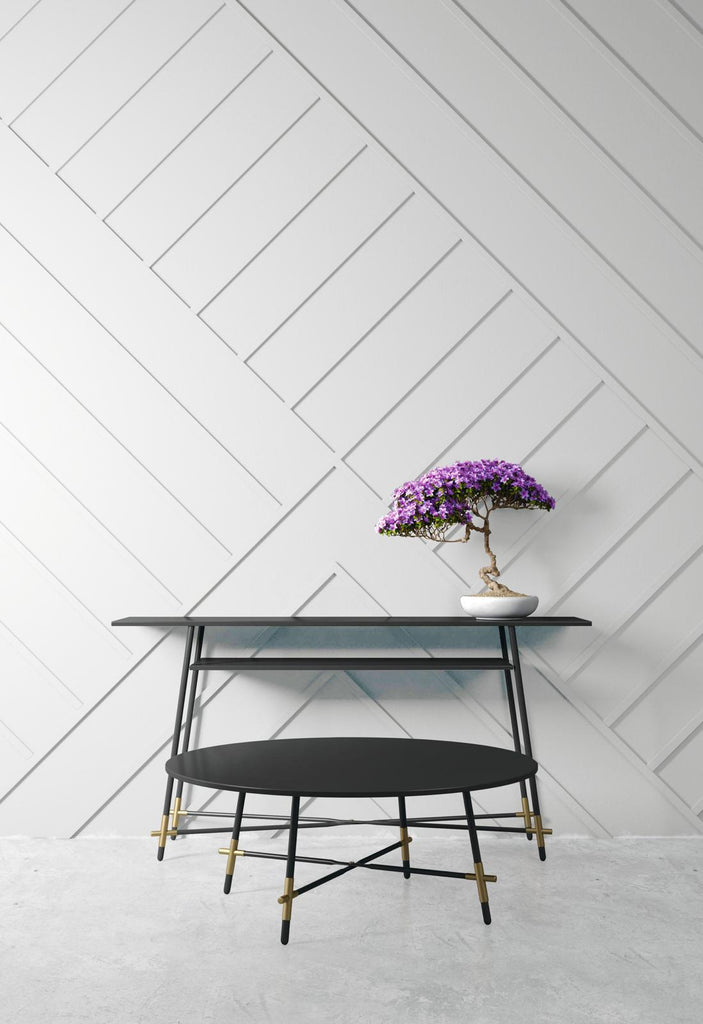 a low, modern black coffee table with golden accessories on the legs