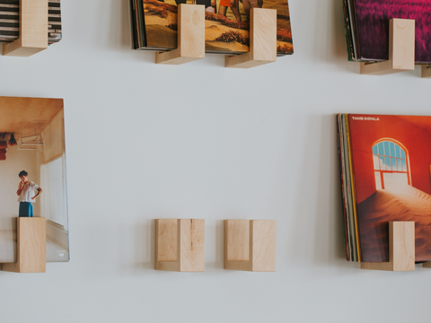 Flip Record Display Shelves in maple on the wall including one empty set waiting to be filled with records