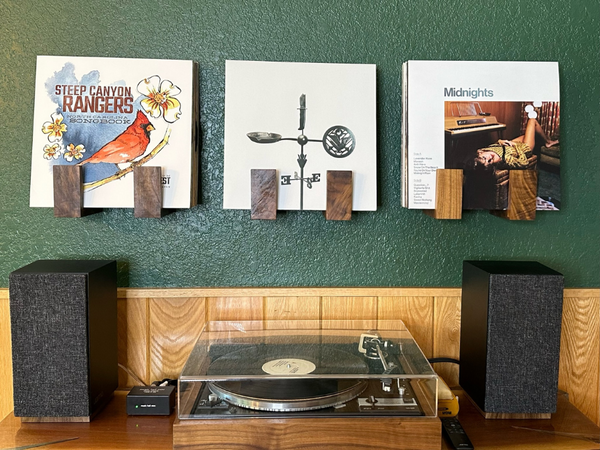 Retro DUAL turntable, powered speakers, and pre-amp along with Flip Record Display Shelves on the wall holding records