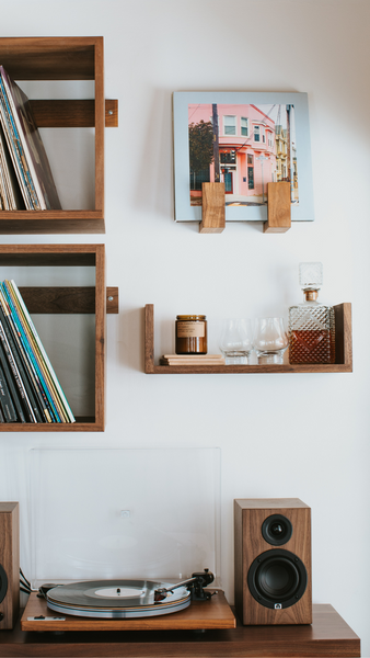 The Reds Pinks and Purples record displayed on the wall in a Flip Record Display Shelf next to two Wall Cubes, above a Floating U Shelf, all over a U-Turn Orbit Special and U-Turn Ethos speakers