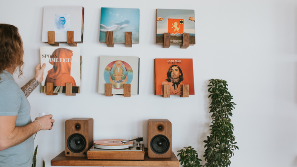 Vintage Bogen turntable paired with YU6 powered speakers on a floating record player shelf under a record wall display with 6 records