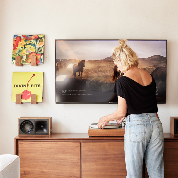 Vintage Pioneer turntable with Klipsch Five Speakers on an Article media console with records displayed on the wall with Flip Record Display Shelves