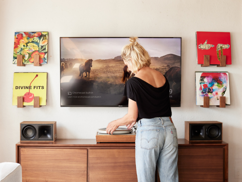 Record display wall around a media center with a vintage turntable