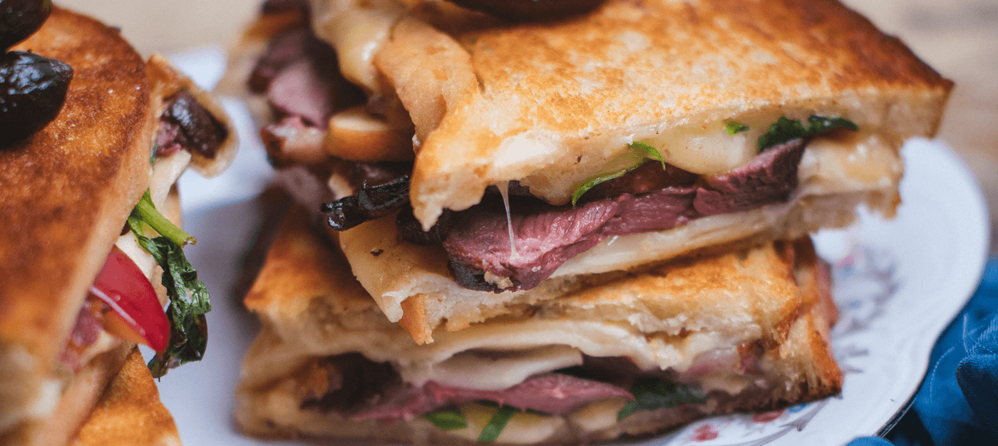 grilled cheese with duck and topping of pickles