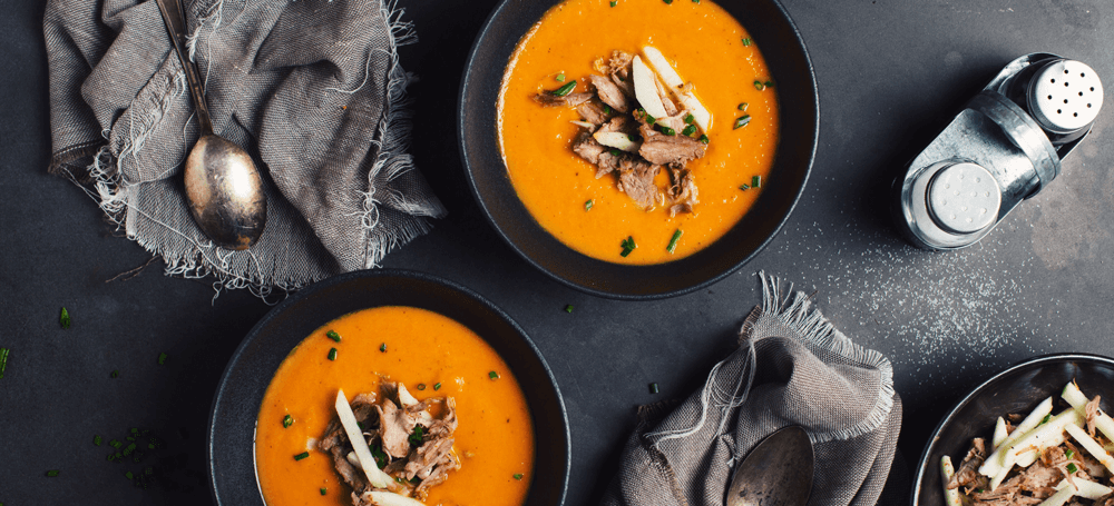 carrot soup with duck meat on top