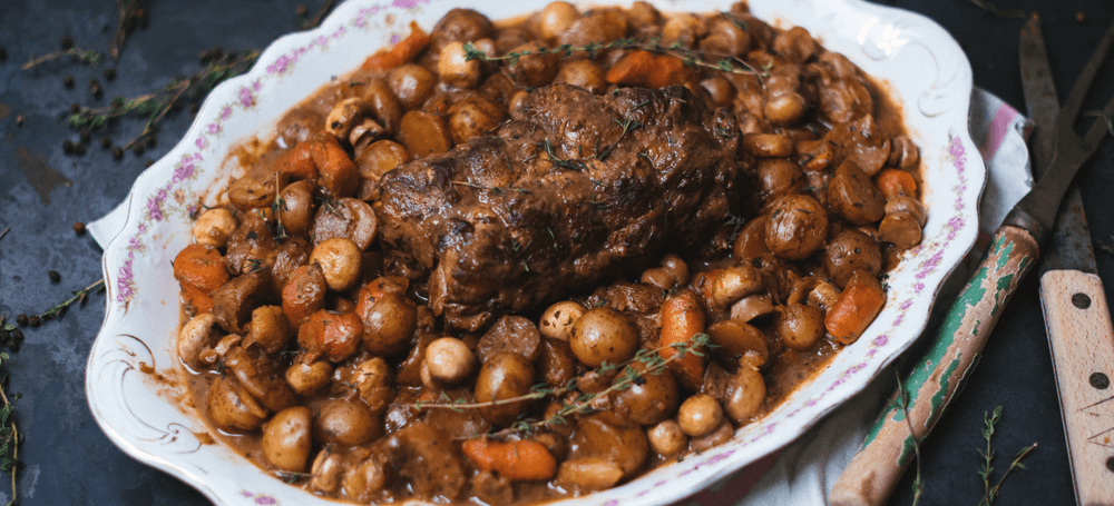 veal roast in plate with potatoes and carrots