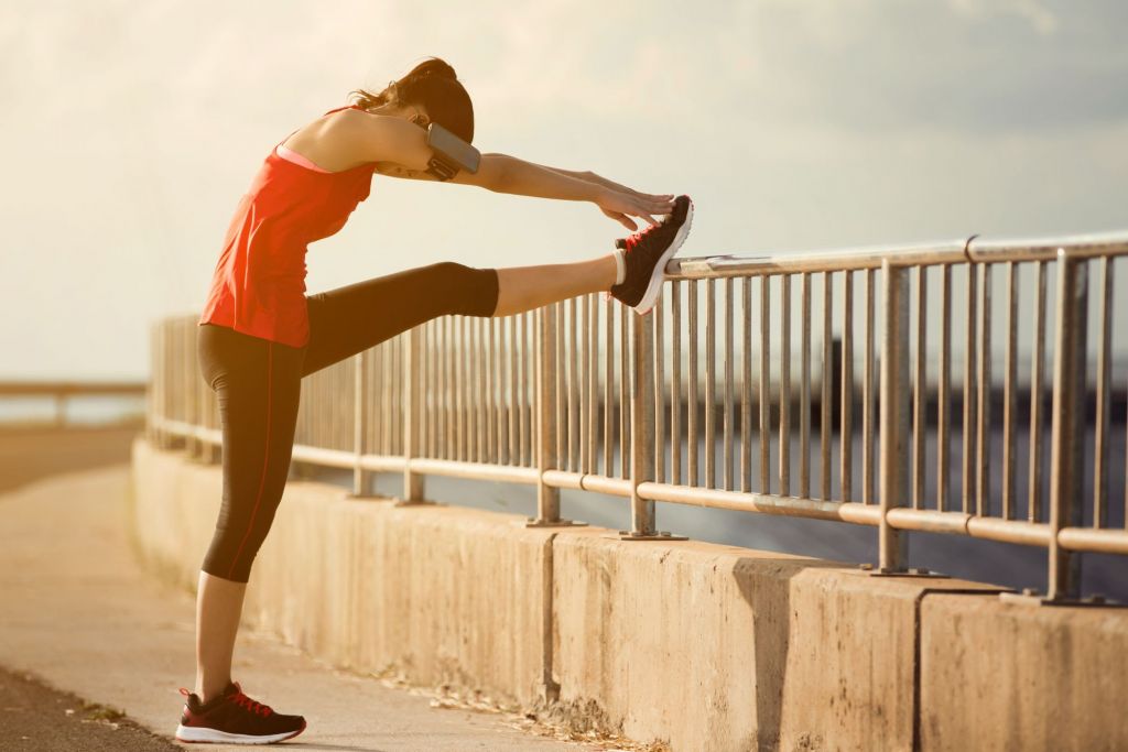 fit girl stretching legs