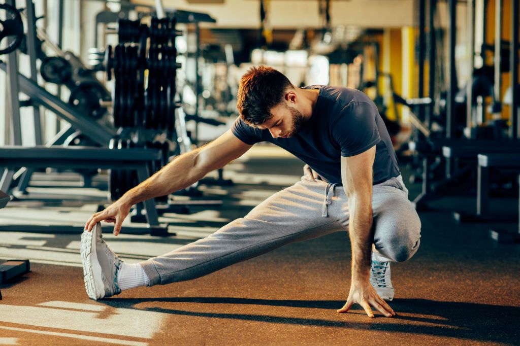 Man stretching in gym