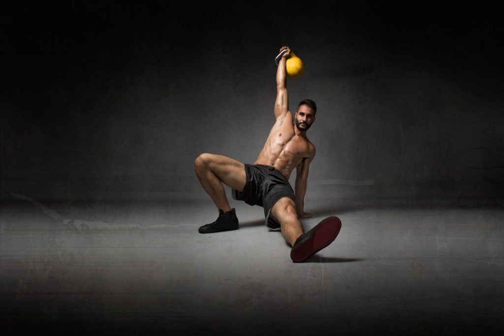 man performs turkish get up kettlebell exercise